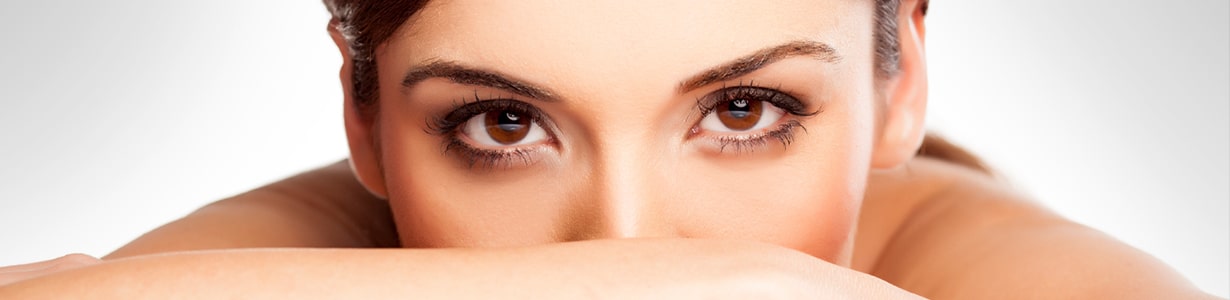 A close up portrait of a young woman with brown eyes and fair skin.