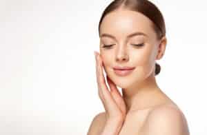 Smiling woman showing off her skin after receiving Restylane dermal filler injections.
